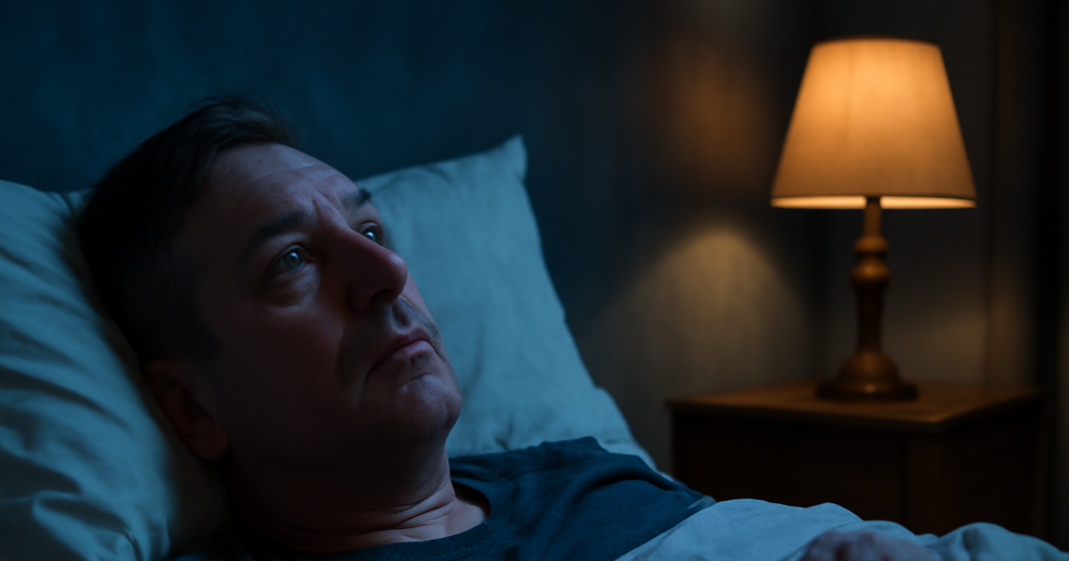 Adult lying awake at night in bed representing sleep disorders and mental health connection